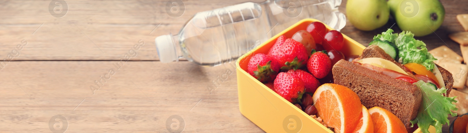 Image of School meal. Lunch box with healthy food on wooden table, space for text. Banner design