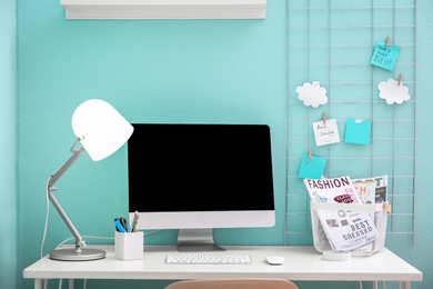 Photo of Comfortable workplace with computer on desk in home office