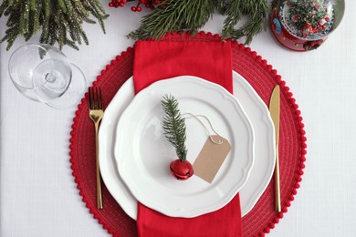 Luxury place setting with beautiful festive decor for Christmas dinner on white table, flat lay