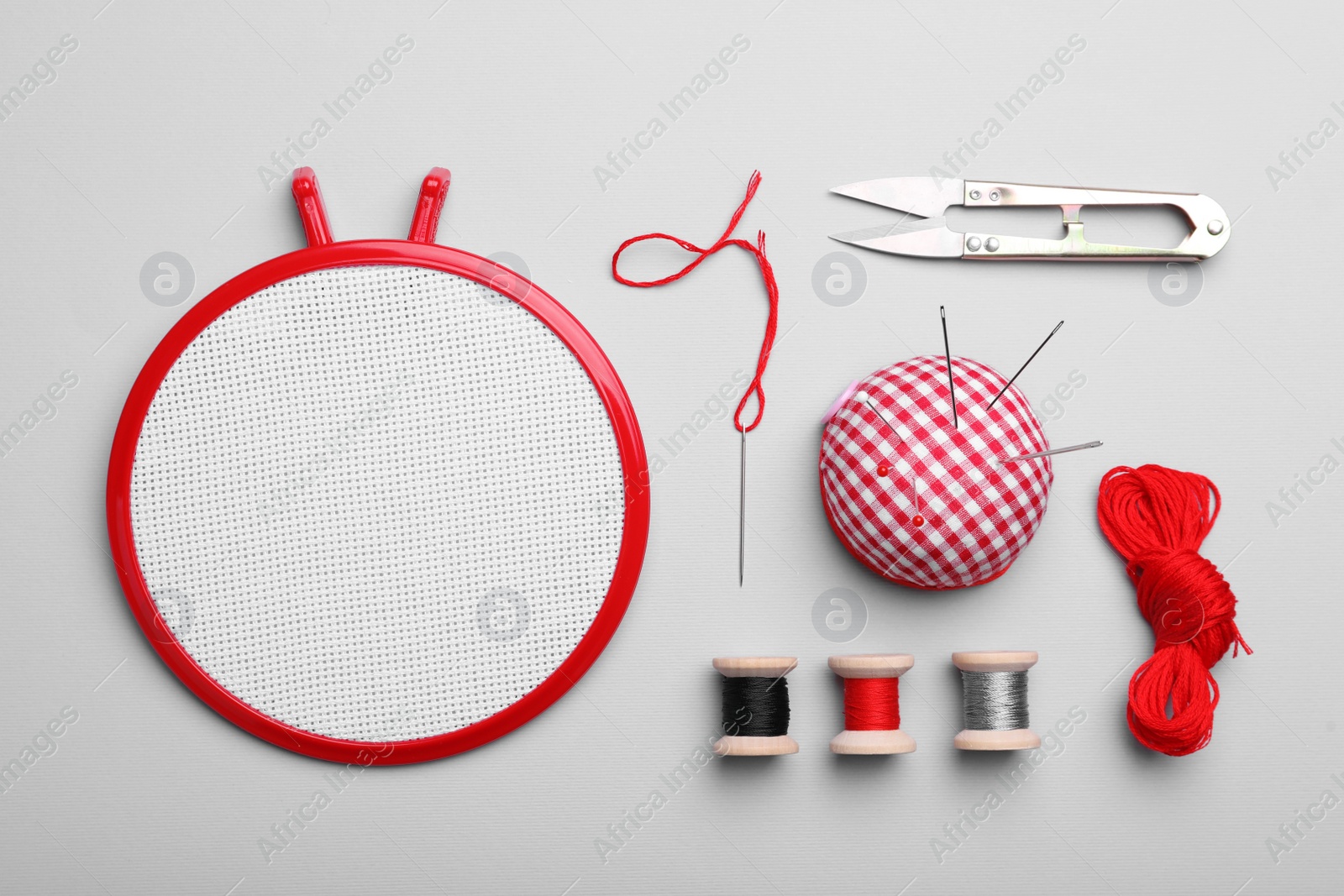 Photo of Flat lay composition with embroidery hoop on light grey background