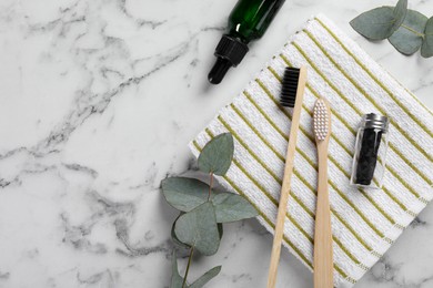 Photo of Flat lay composition with bamboo toothbrushes on white marble table. Space for text