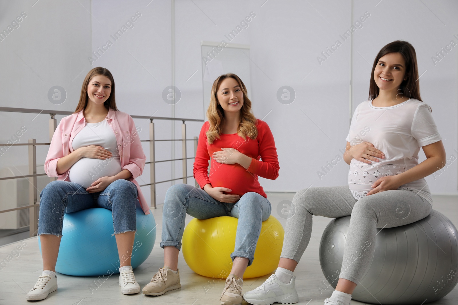 Photo of Group of pregnant women at courses for expectant mothers indoors