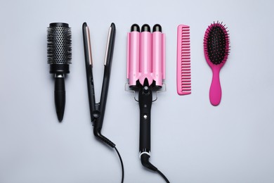 Photo of Flat lay composition of different professional hairdresser tools on white background