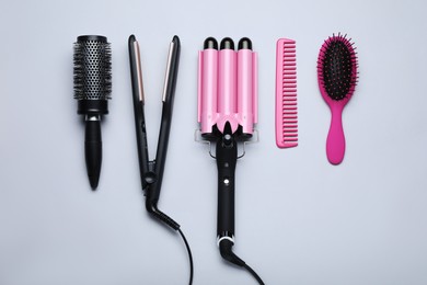 Flat lay composition of different professional hairdresser tools on white background