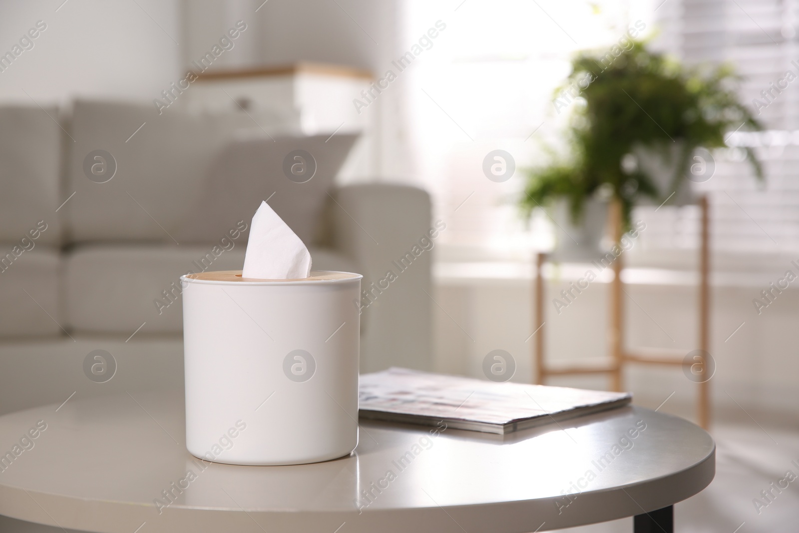 Photo of Box with paper tissues on light table in living room. Space for text