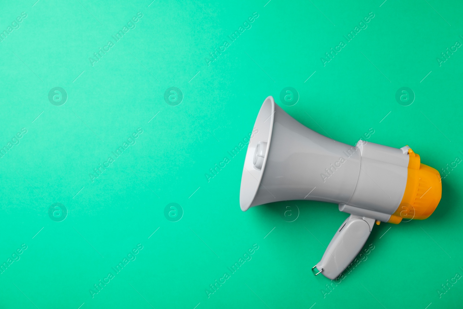 Photo of Electronic megaphone on color background