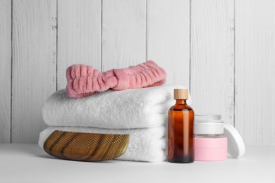 Photo of Composition with different spa products on white table against wooden background