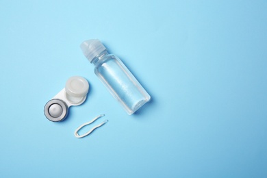Flat lay composition with contact lens accessories on color background