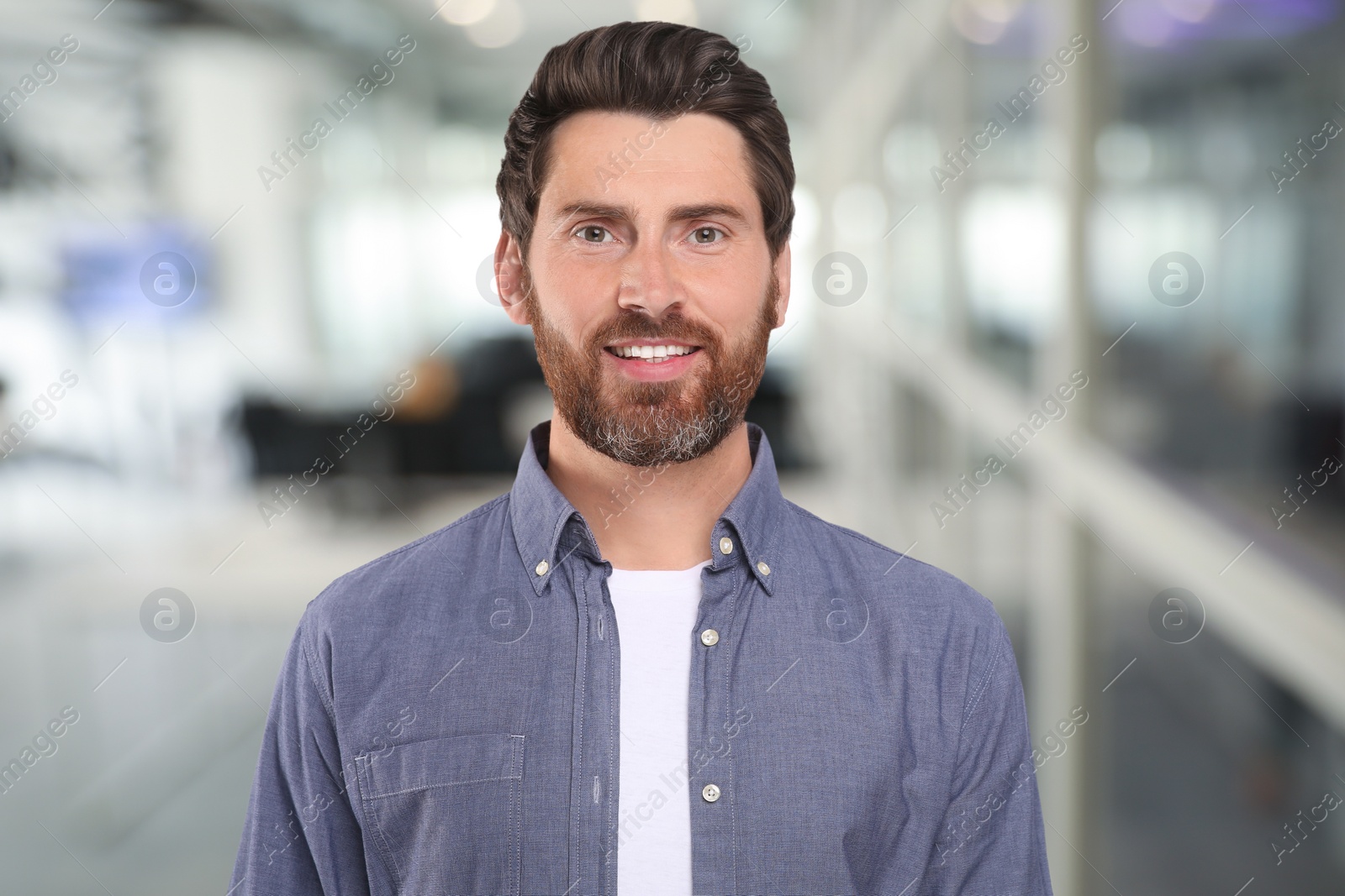 Image of Portrait of handsome confident man in office