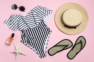 Photo of Flat lay composition with stylish beach accessories on pink background