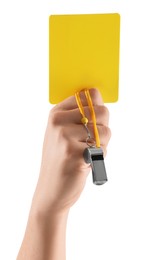 Referee holding yellow card and whistle on white background, closeup
