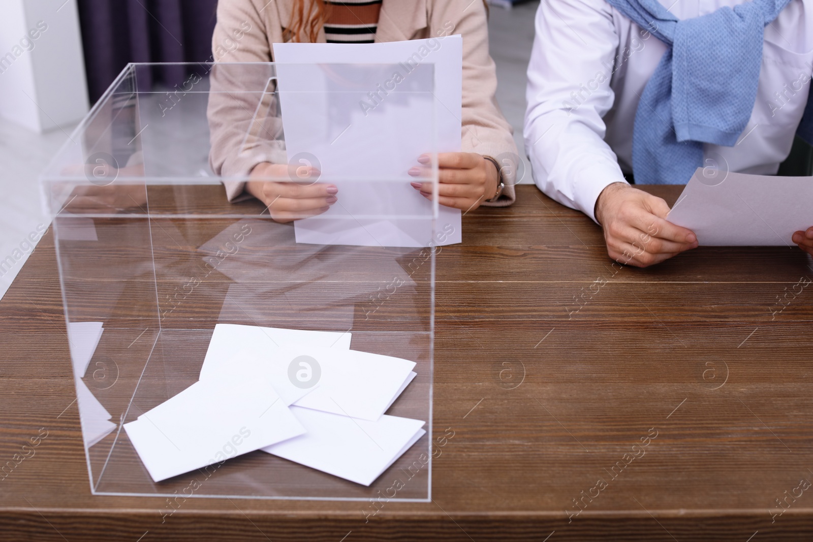 Photo of Polling station workers at table with ballot box