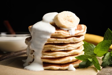 Tasty pancakes with sliced banana served on table, closeup