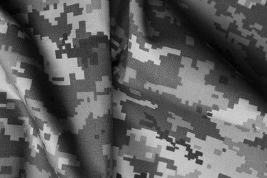 Image of Texture of crumpled camouflage fabric as background, top view. Black and white effect