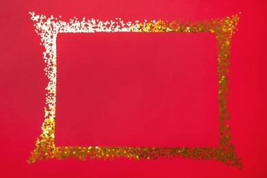 Photo of Frameshiny gold glitter on red background, flat lay. Space for text