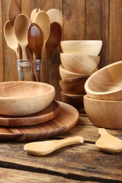 Many different wooden dishware and utensils on table