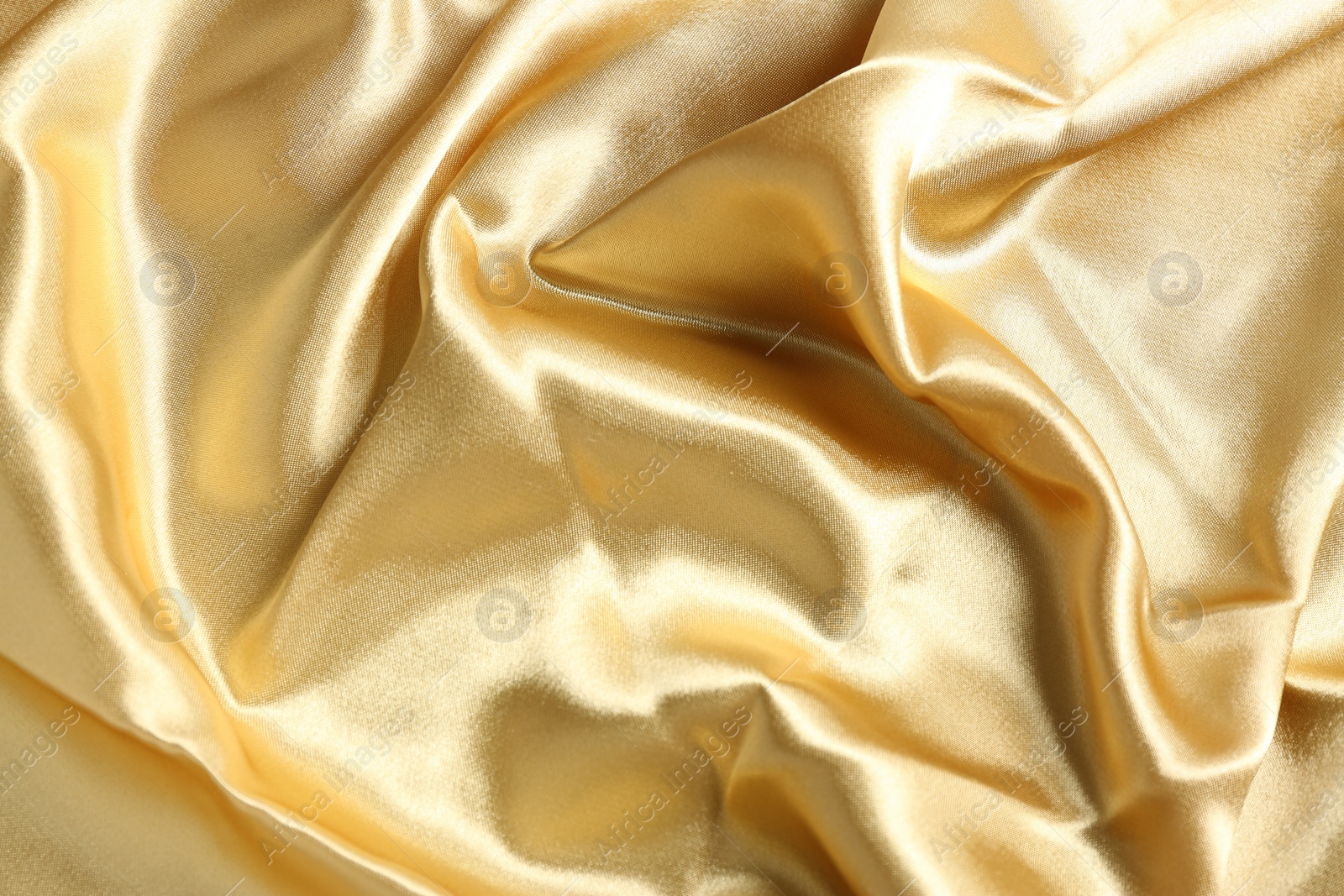 Photo of Golden shiny fabric as background, top view