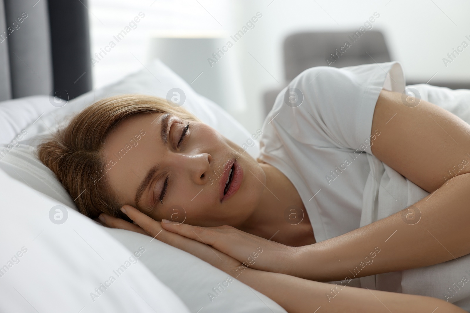 Photo of Woman snoring while sleeping in bed at home