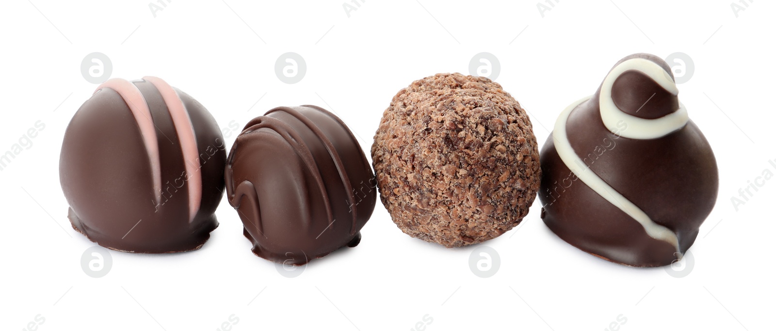 Photo of Many different delicious chocolate truffles on white background