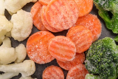 Different frozen vegetables on grey table, flat lay