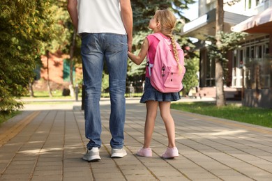 Little girl with her father on way to school