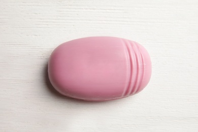 Soap bar on white wooden background, top view