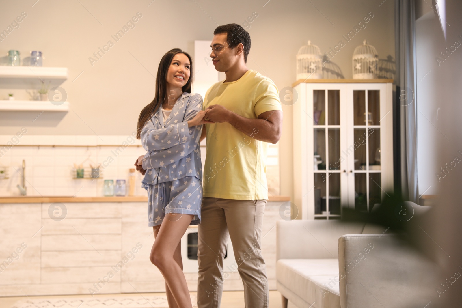 Photo of Lovely young interracial couple dancing at home