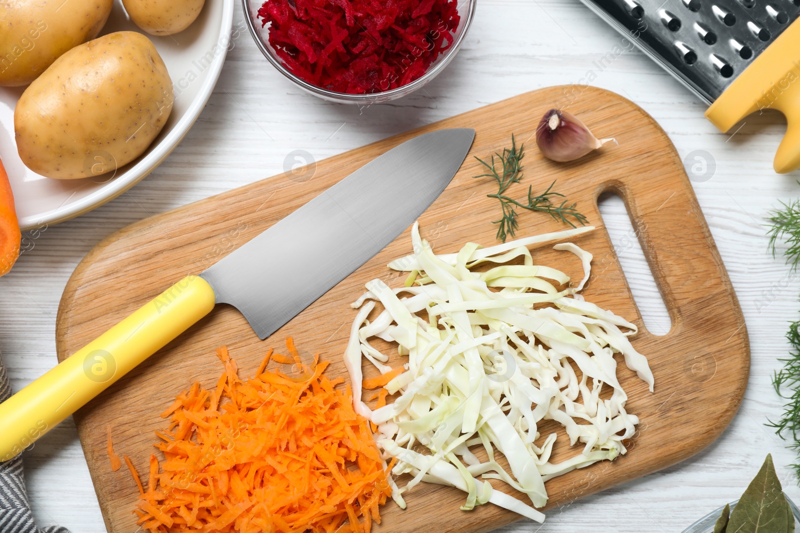 Photo of Fresh ingredients for borscht on white wooden table, flat lay