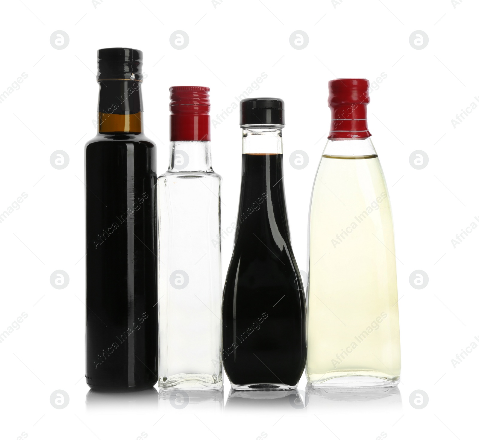 Photo of Bottles with different kinds of vinegar on white background