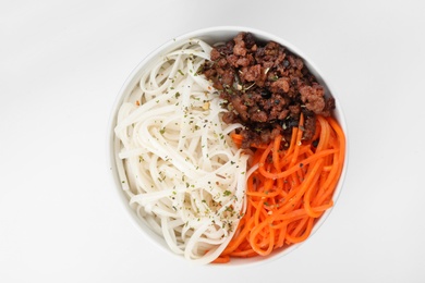 Photo of Bowl with rice noodles, meat and carrot on white background, top view