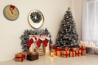 Stylish Christmas interior with decorated fir tree and fireplace