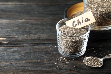 Photo of Composition with chia seeds on wooden background. Space for text