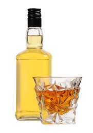 Photo of Glass and bottle of whiskey isolated on white