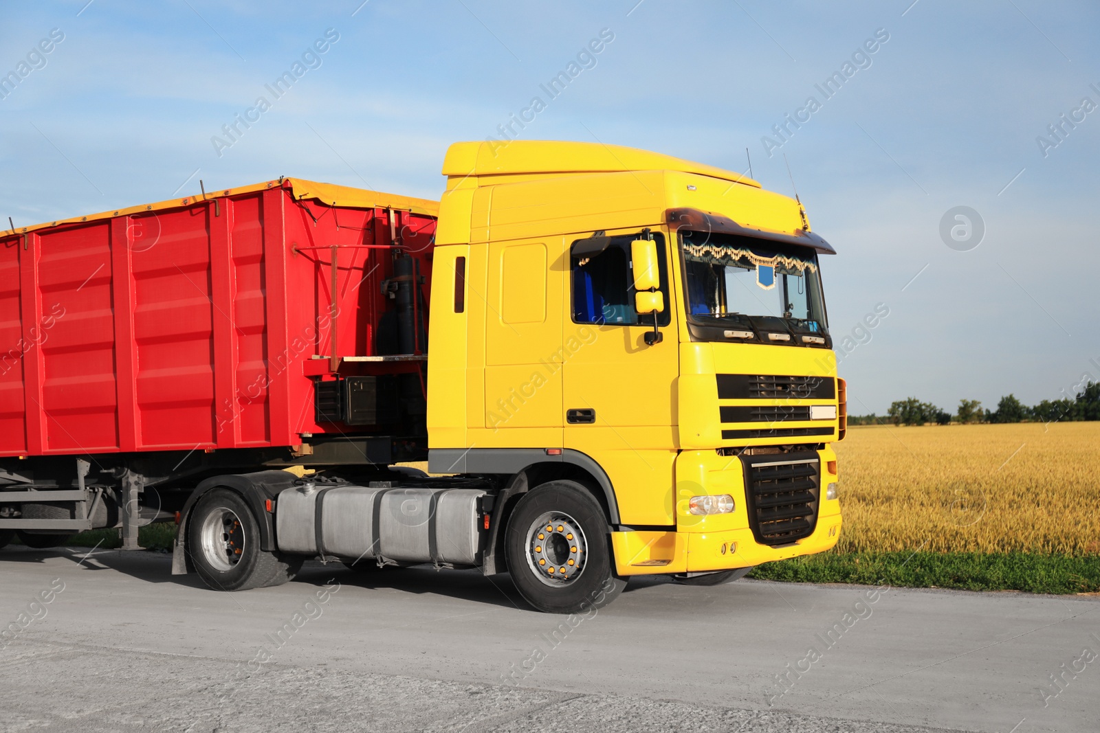 Photo of Modern bright truck parked on country road