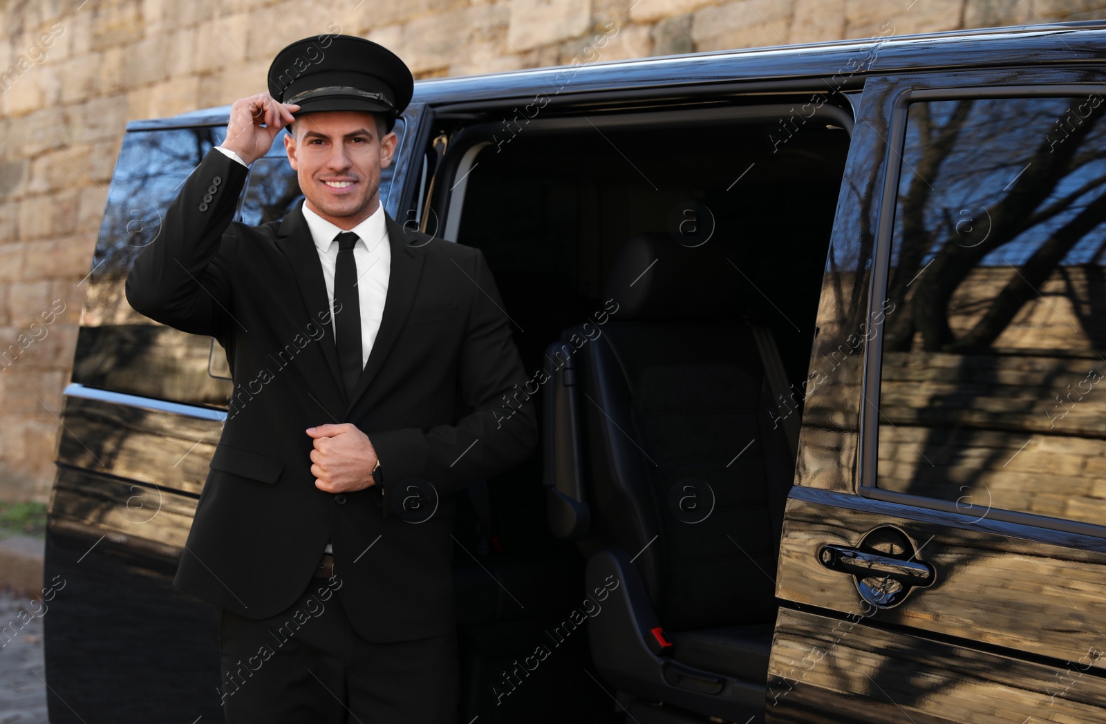 Photo of Professional driver near luxury car. Chauffeur service