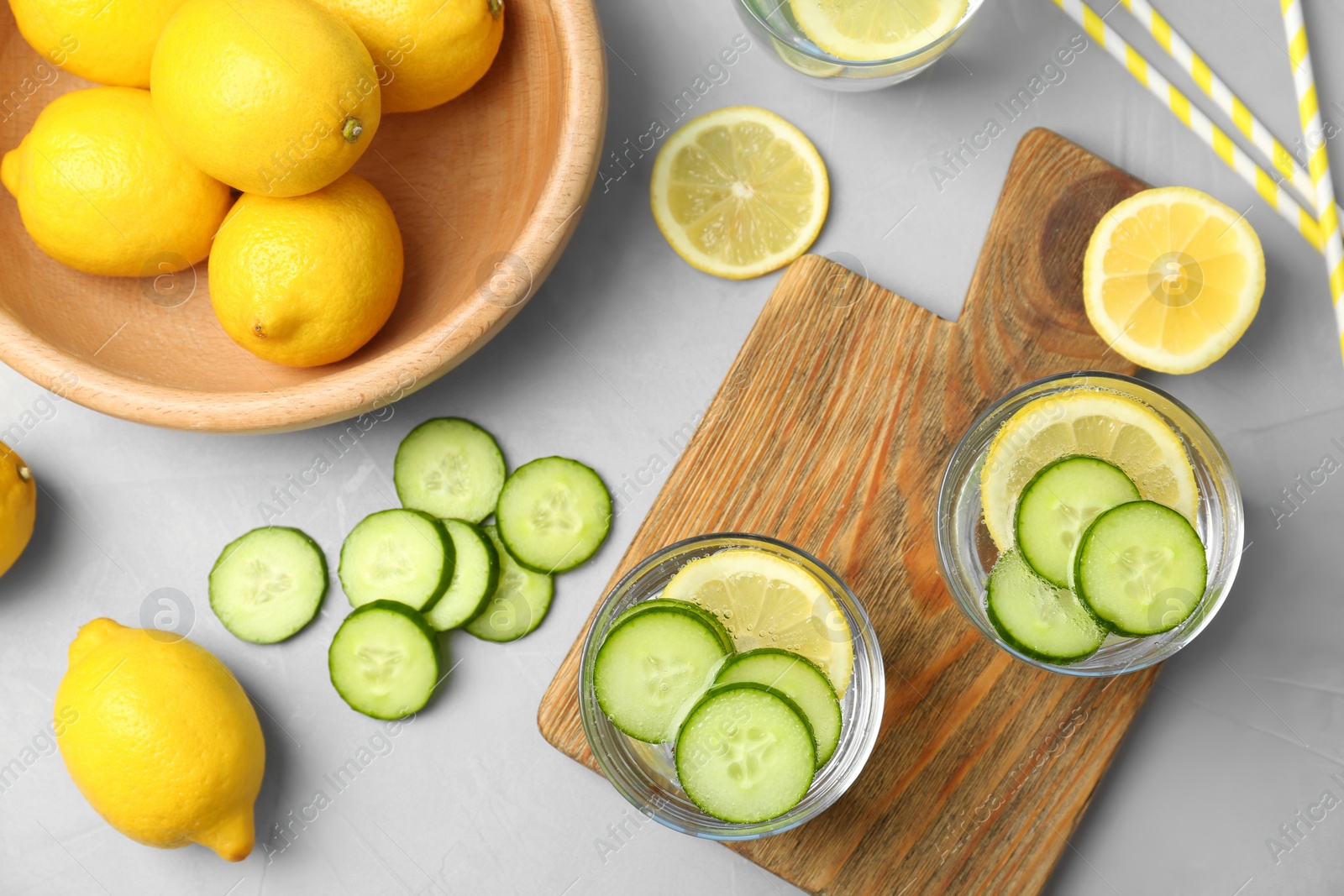 Photo of Flat lay composition with delicious natural lemonade on light background