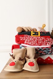 Photo of Baby Christmas clothes and accessories on wooden table