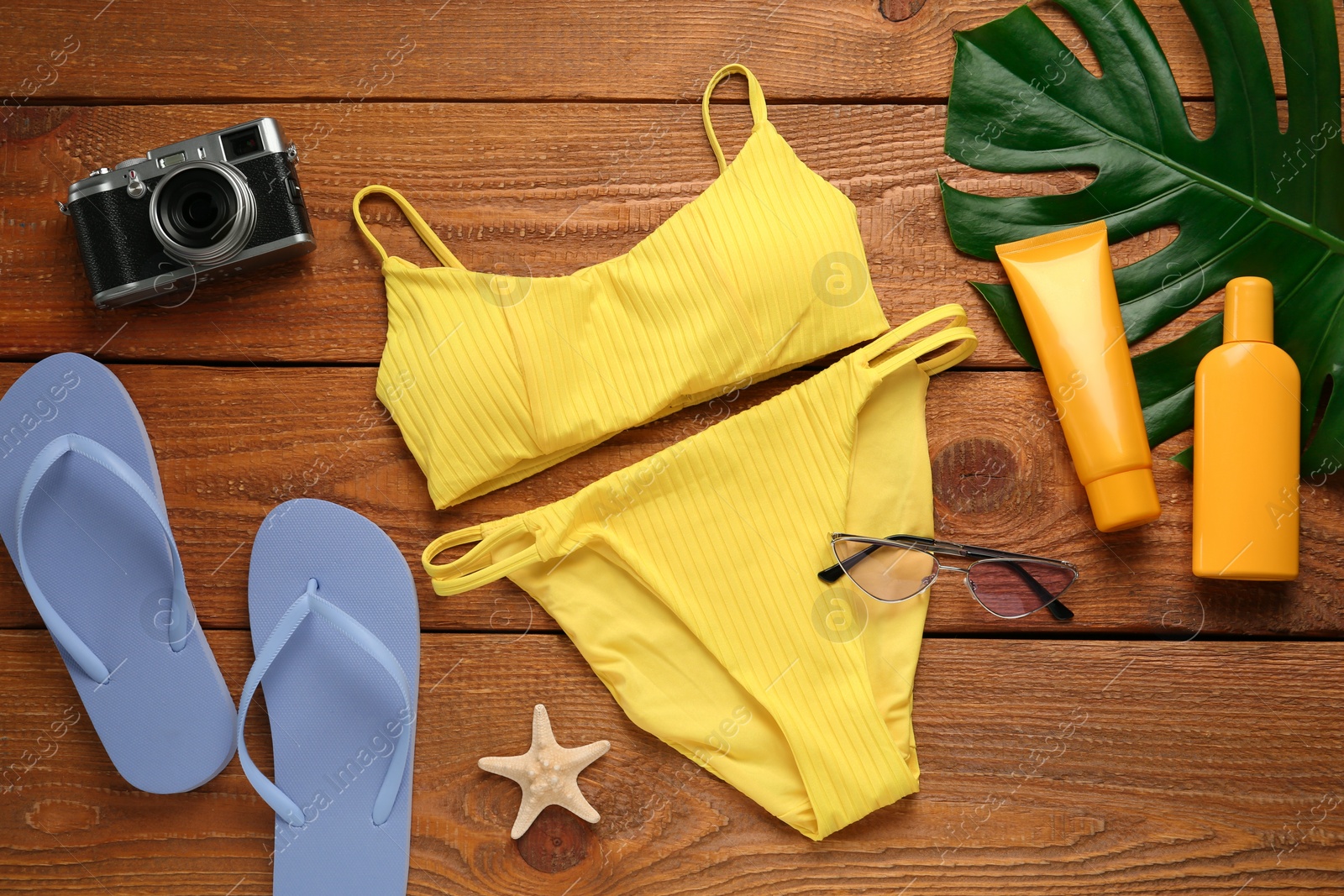 Photo of Different beach objects on wooden background, flat lay