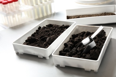 Containers with soil samples on table. Laboratory research