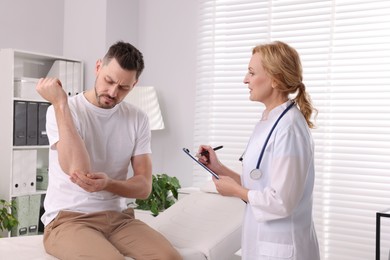 Photo of Doctor listening to patient's complaints during consultation in clinic