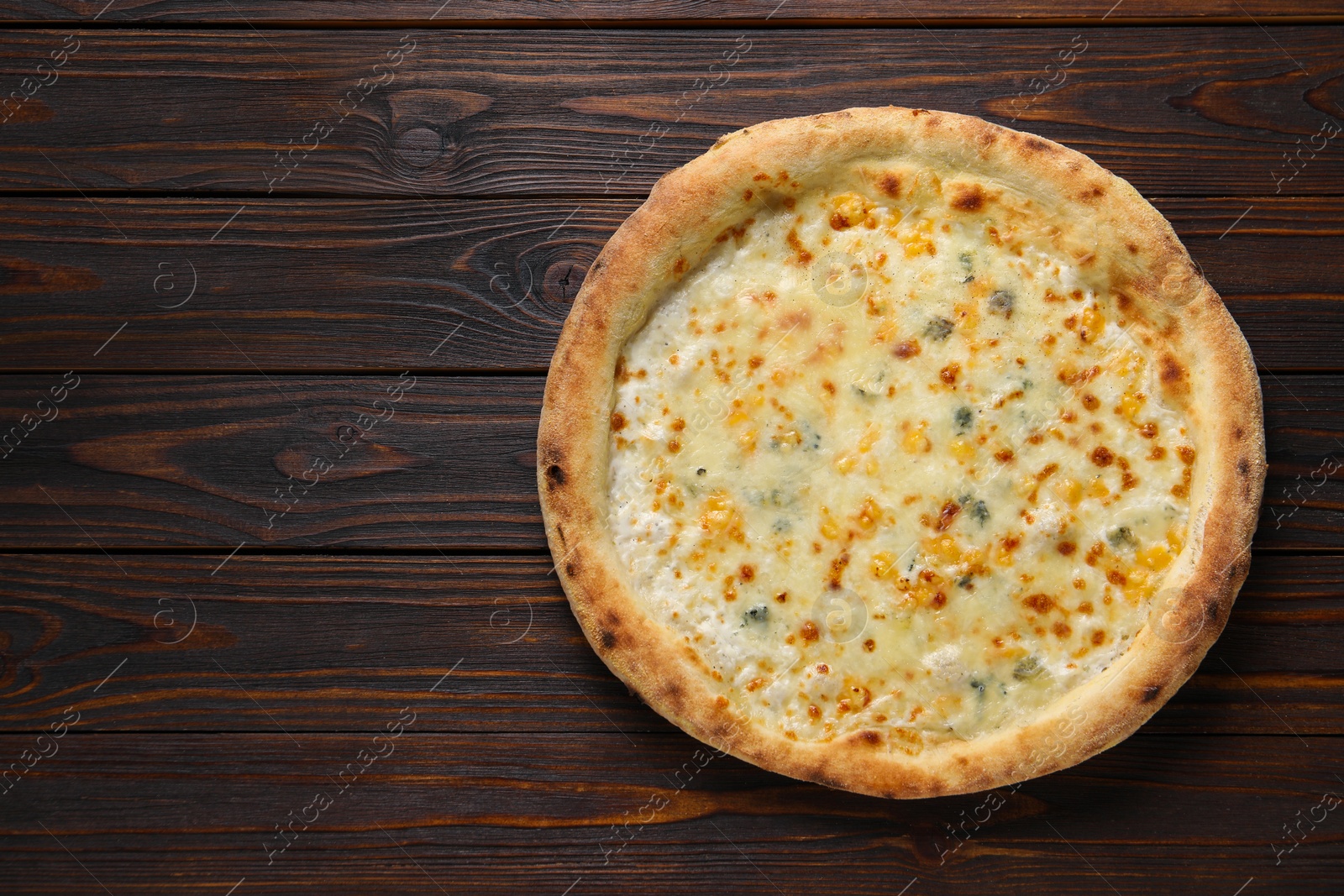 Photo of Delicious cheese pizza on wooden table, top view. Space for text