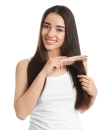 Beautiful young woman with hair comb on white background