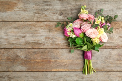 Photo of Bouquet of beautiful fragrant flowers on wooden background