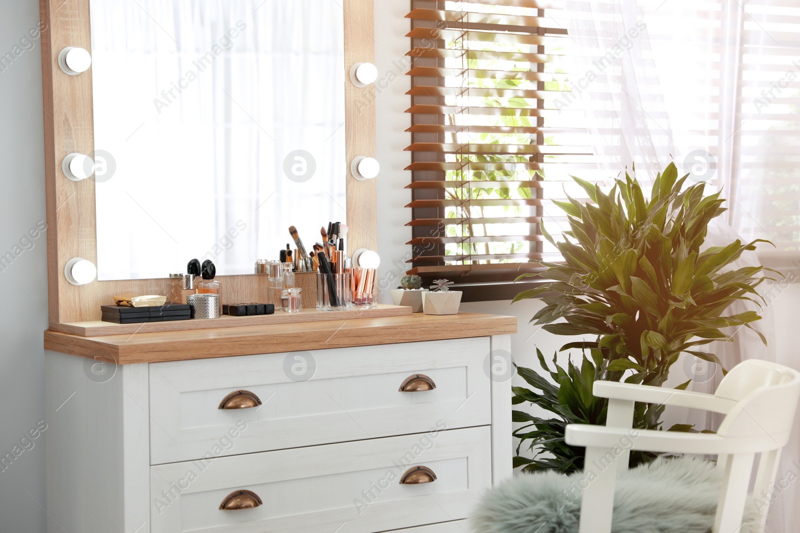 Photo of Dressing table with luxury cosmetics and accessories in room near window