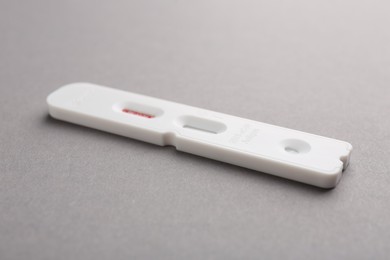 Photo of Disposable express test on grey background, closeup