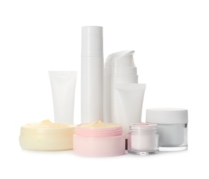 Different containers with hand cream and other cosmetic on white background