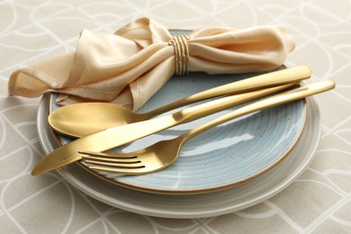 Photo of Stylish setting with cutlery, plates and napkin on table