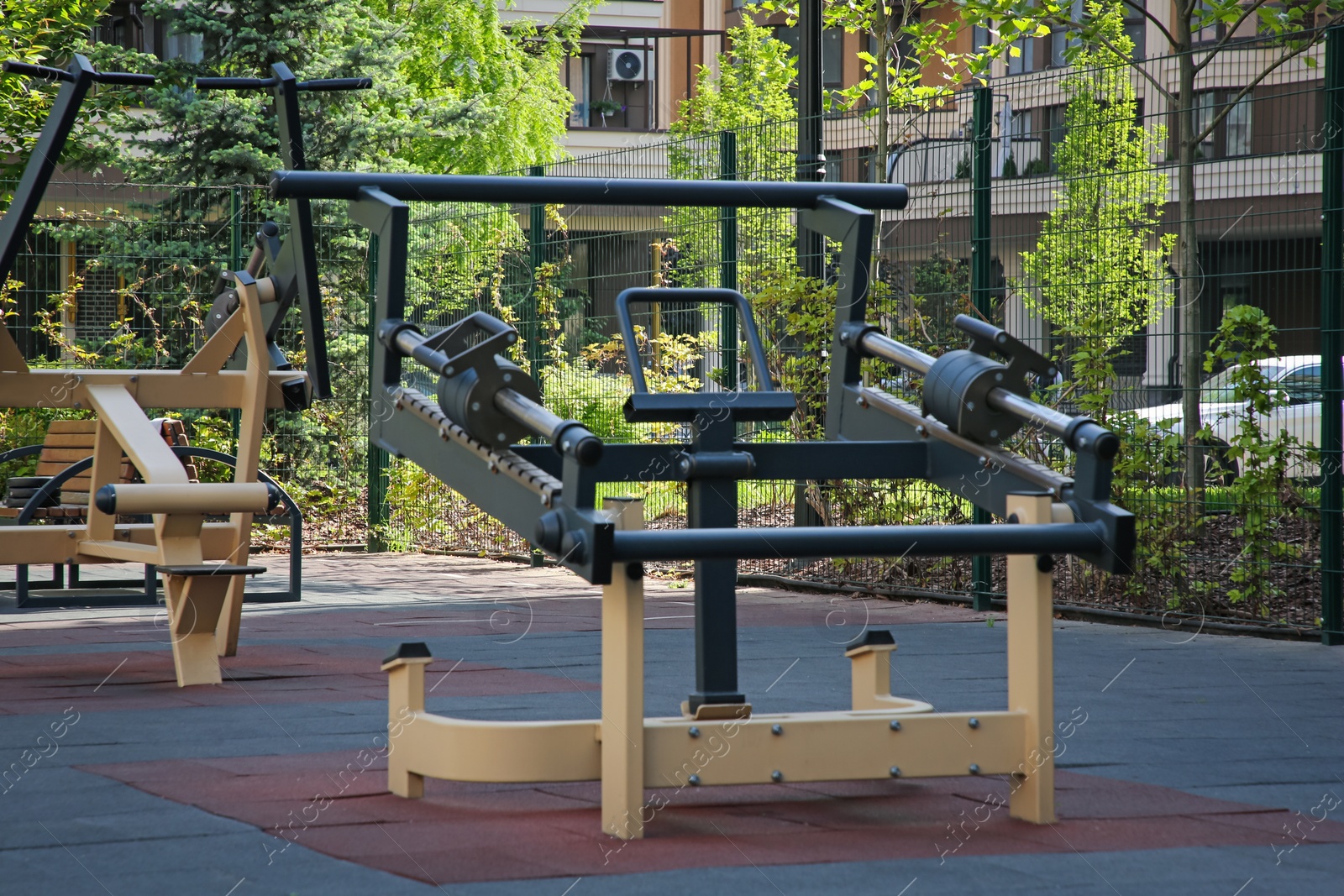 Photo of Empty outdoor gym with exercise simulator in residential area