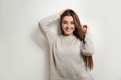 Photo of Beautiful young woman in warm sweater on white background