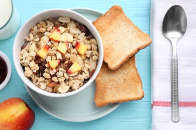 Flat lay composition with muesli and toasts on light blue wooden table. Healthy breakfast